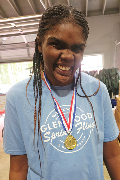 Glenwood student Kierra Brown smiles after receiving gold medal.