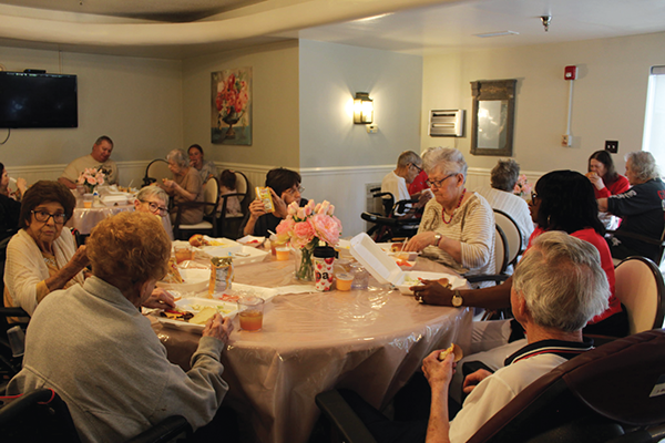 The residents enjoying a 4th of July meal