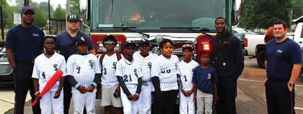 Jefferson County Baseball Little League players pose alongside Bessemer's Fire
Department personnel