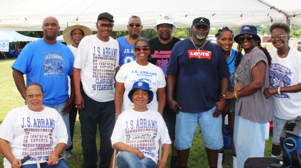 J.S. Abrams alumni, several in Class of 1983 shirts, under a tent at the annual class day