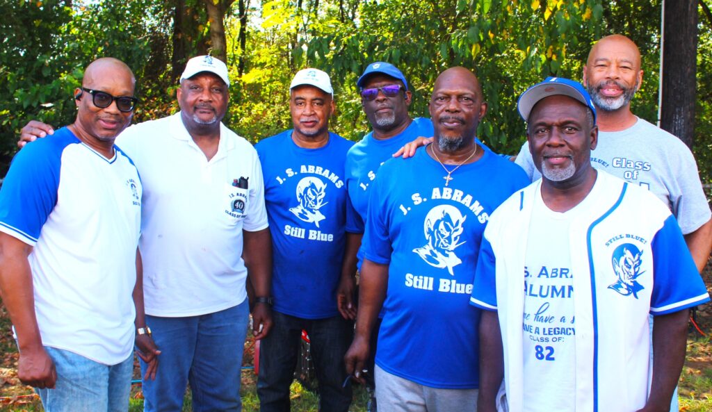 Alumni at the class day, several in "Still Blue" shirts and one in a Class of 1982 shirt.