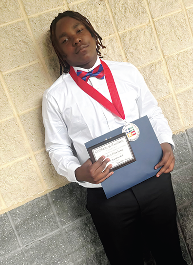 Aaden Hawkins pictured with awards during school awards day