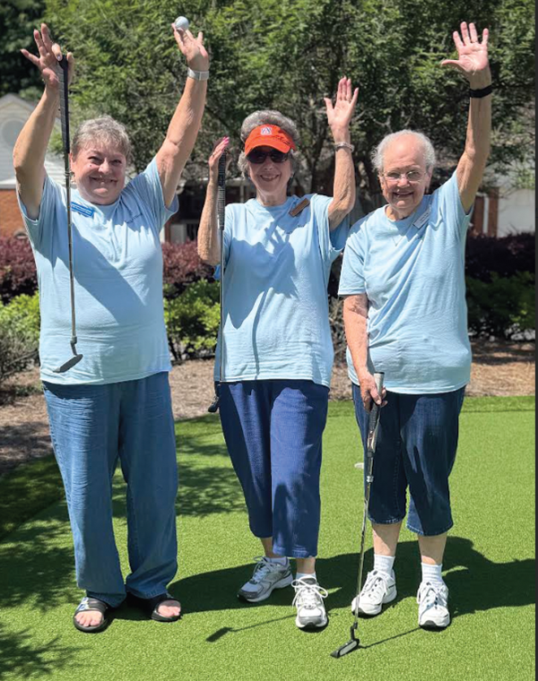 Golfers celebrating a successful putt