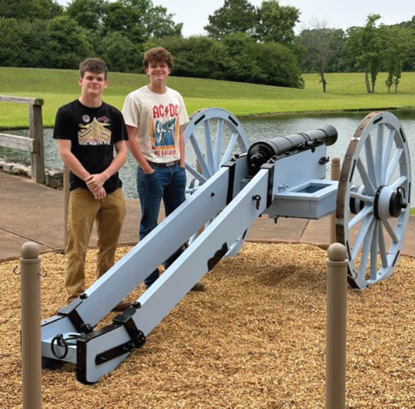 Isaiah Barthhold and Andrew Harney with cannon they helped restore