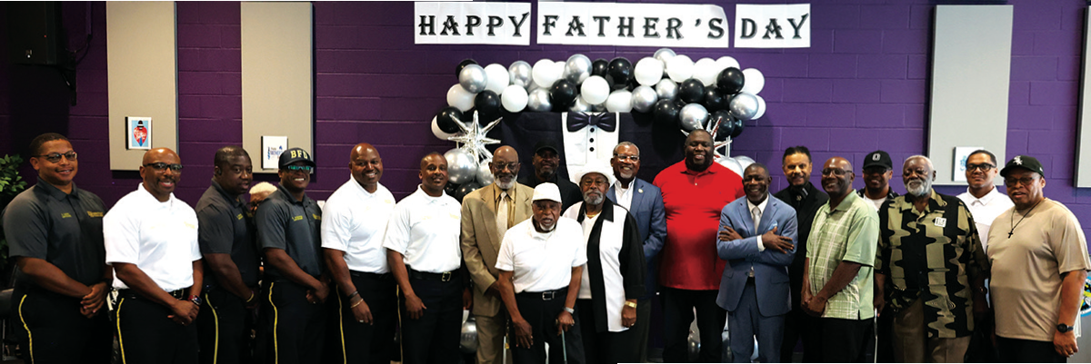 Mayor Gulley, Bessemer Firemen, Mr. Mykee Jackson and other fathers pose together during recent program